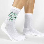 Alpha Epsilon Phi sorority name in sorority color digitally printed on soft white cotton crew socks make the perfect accessory.