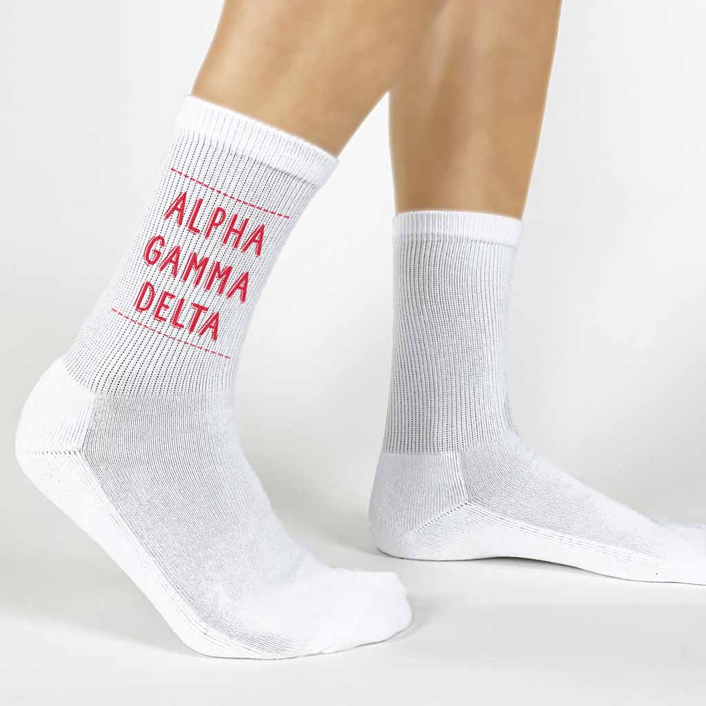 Highlight your Alpha Gamma Delta pride with a pair of these Alpha Gamma Delta white cotton crew socks printed in sorority colors. 