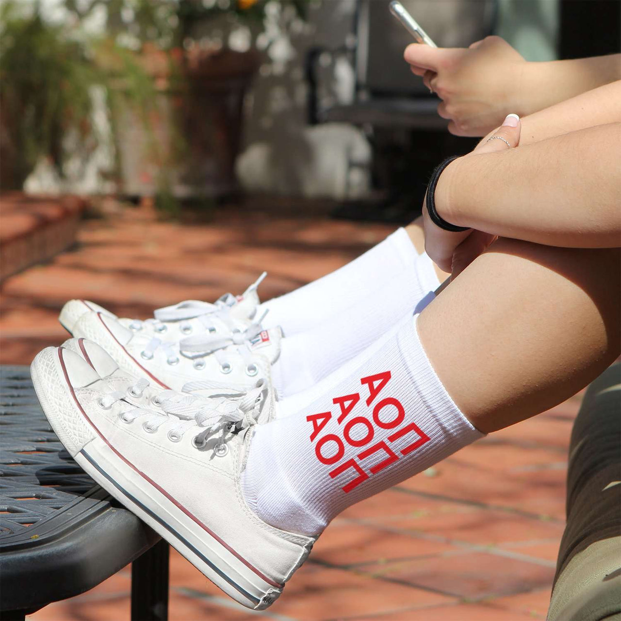 Alpha Omicron Pi sorority letters in repeating pattern custom printed on white cotton crew socks