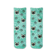 Custom photo face socks digitally printed and personalized using your photo cropped in all over design with paw prints printed on turquoise wash background on cotton crew socks.