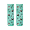 Custom photo face socks digitally printed and personalized using your photo cropped in all over design with paw prints printed on turquoise wash background on cotton crew socks.