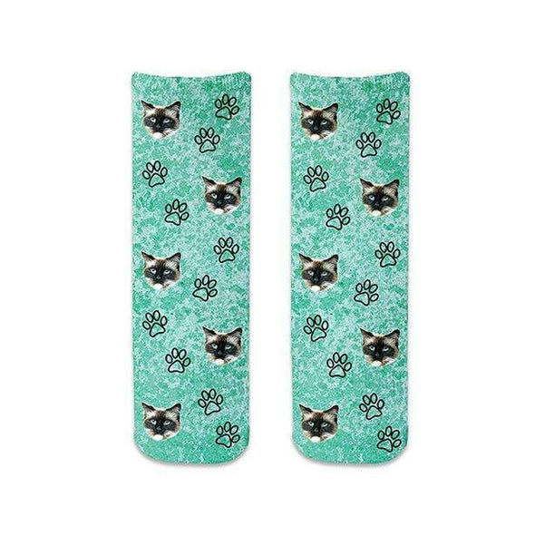 Custom photo face socks digitally printed and personalized using your photo cropped in all over design with paw prints printed on turquoise wash background on cotton crew socks.