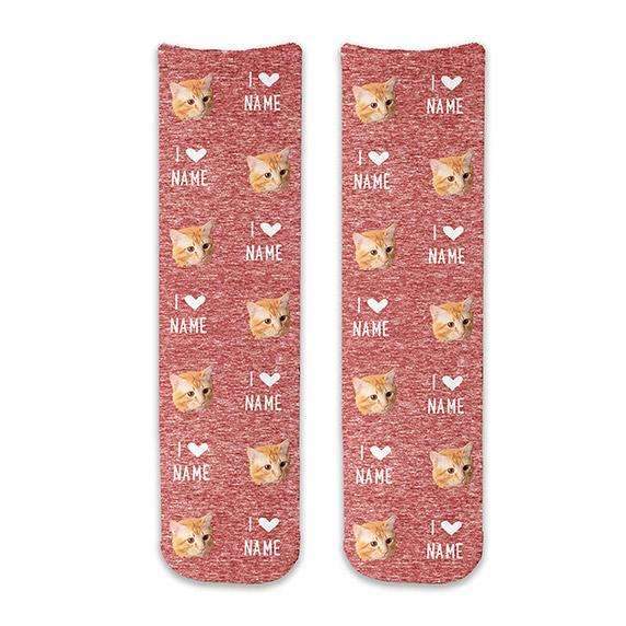 Custom printed photo face socks with an all over print of faces and you can personalize with a name digitally printed on red granular background on cotton crew socks.