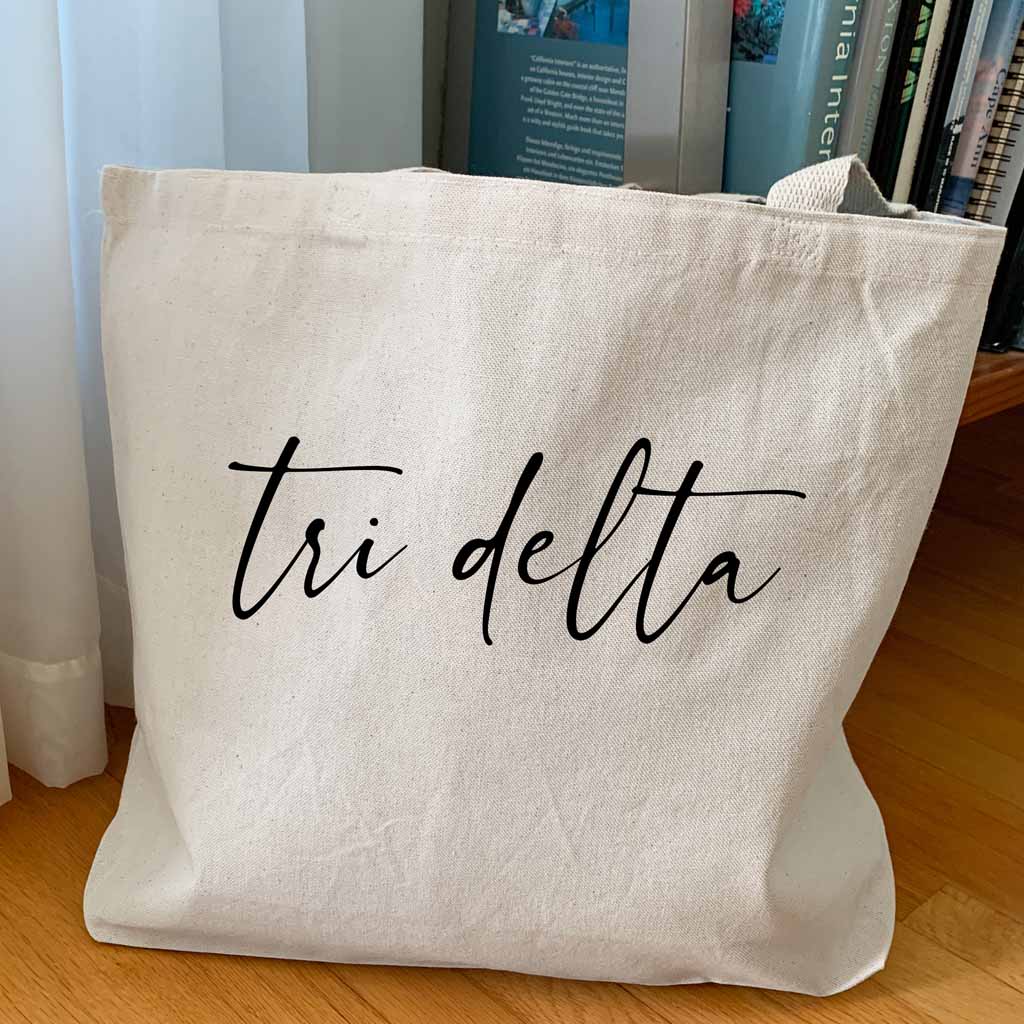 Tri Delta sorority nickname custom printed in script writing on canvas tote bag is a unique gift for all your sorority sisters.